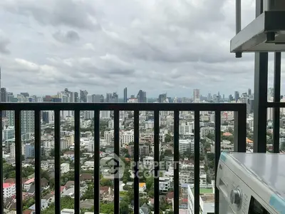 Stunning cityscape view from high-rise balcony with modern appliances.