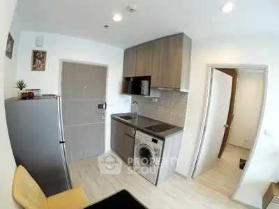 Modern compact kitchen with washing machine and sleek cabinetry