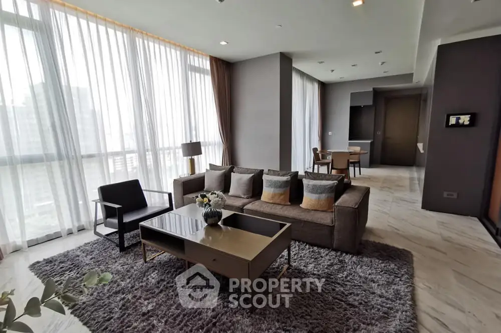 Spacious modern living room with large windows and stylish decor