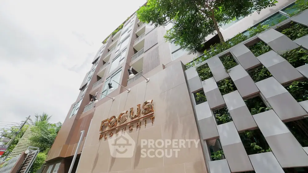 Modern urban building with lush greenery and unique facade design