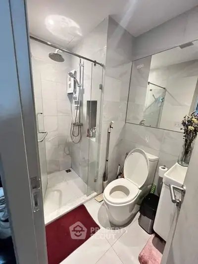 Modern bathroom with glass shower and sleek fixtures, perfect for contemporary living.