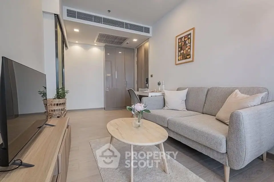 Modern living room with cozy sofa and stylish decor in a contemporary apartment.