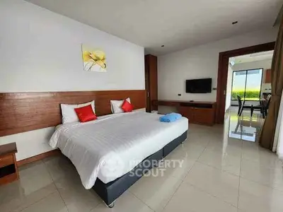 Spacious bedroom with modern decor and natural light