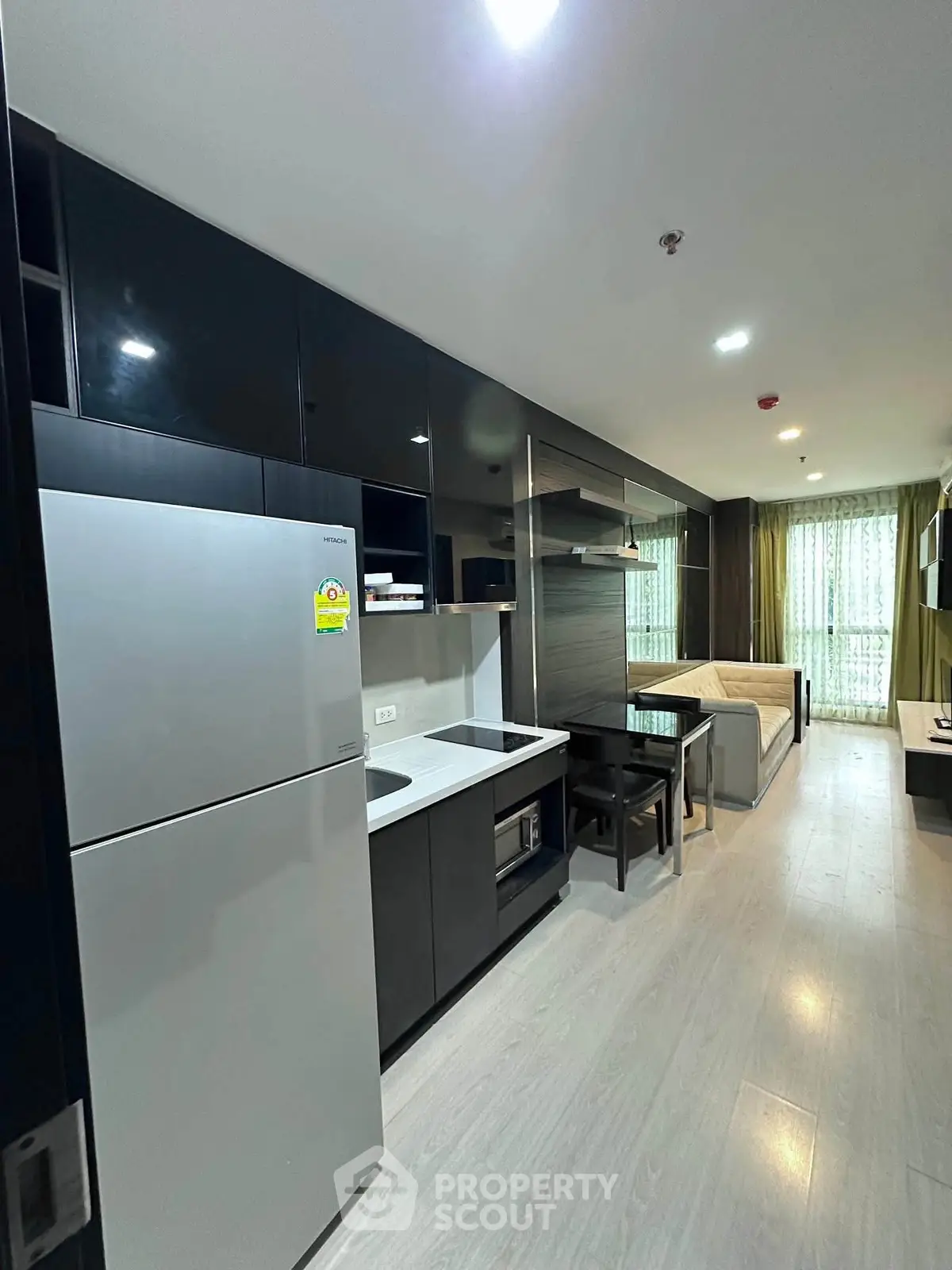 Modern studio apartment with sleek kitchen and cozy living area