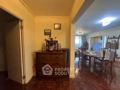 Spacious living and dining area with wooden flooring and elegant decor