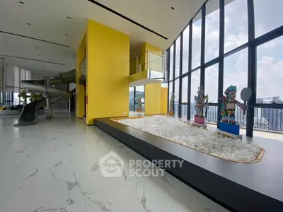 Luxurious modern interior with high ceilings and unique artistic decor in a spacious living area.