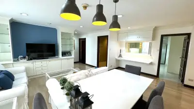 Spacious modern living room with stylish dining area and open kitchen layout.