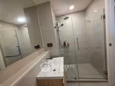 Modern bathroom with glass shower and sleek vanity