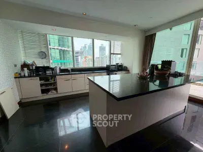 Spacious modern kitchen with city view and sleek black countertops