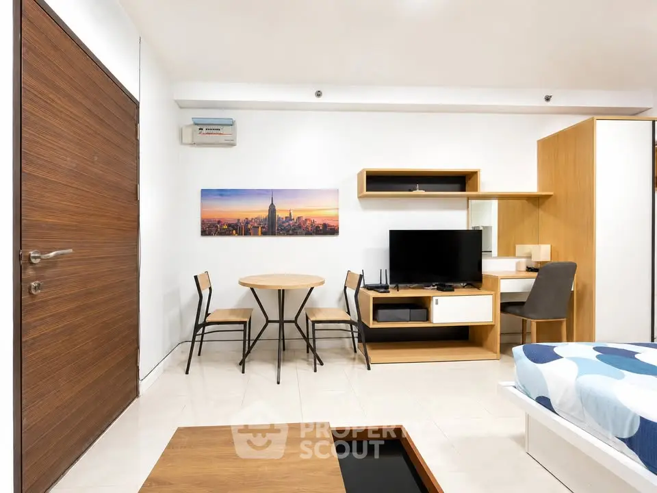 Modern studio apartment with stylish furniture and wall art