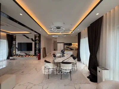 Luxurious modern living room with marble flooring, elegant lighting, and stylish dining area