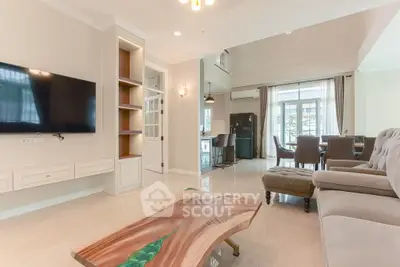 Spacious living room with modern decor and open layout, featuring a stylish wooden coffee table.