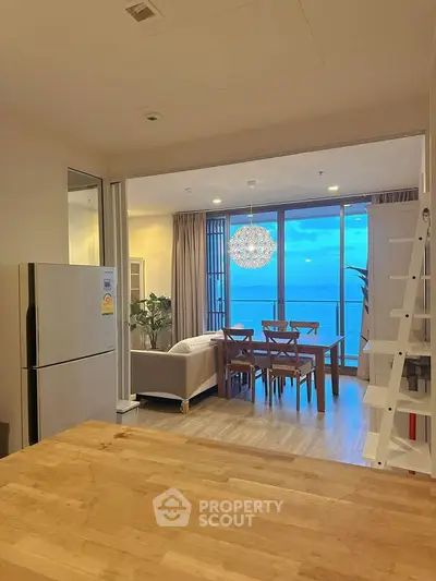 Stunning open-layout living room with ocean view and modern dining area