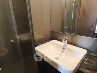 Modern bathroom with sleek sink and glass shower enclosure