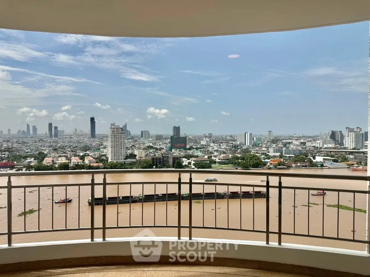 Stunning cityscape view from a high-rise balcony overlooking a river, perfect for urban living.
