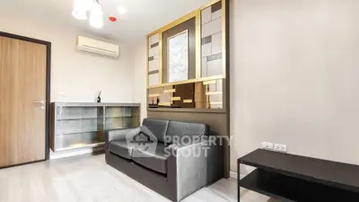 Modern living room with sleek black sofa and stylish wall decor