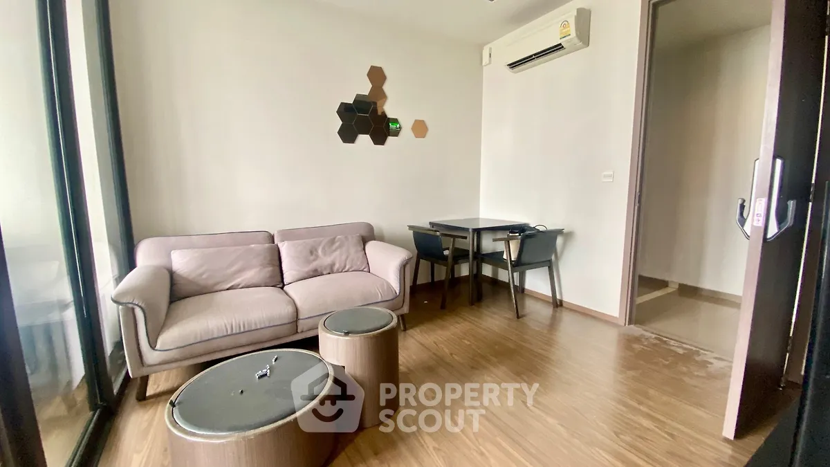 Modern living room with cozy sofa and stylish decor in a well-lit apartment.