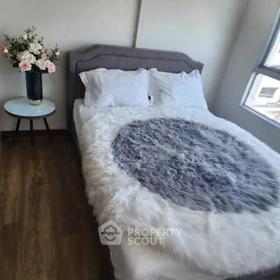 Cozy bedroom with plush bedding and elegant floral decor, perfect for relaxation.