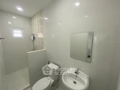 Modern bathroom with sleek white tiles and compact design