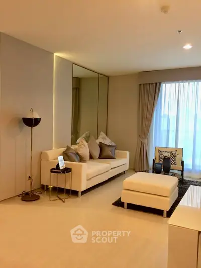 Elegant living room with modern decor and large window, perfect for relaxation and entertaining.