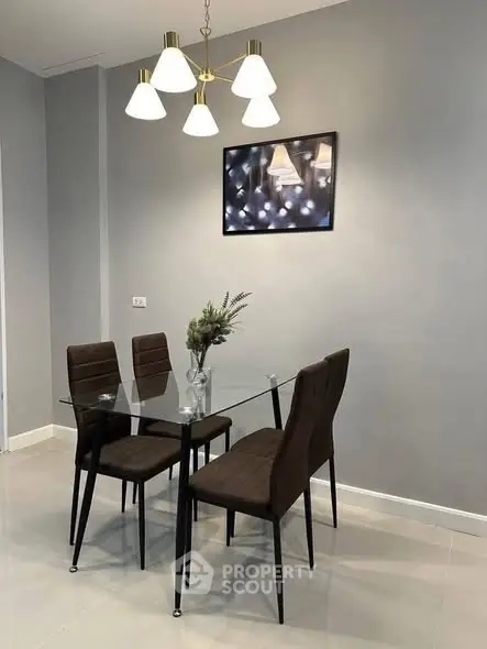 Modern dining area with glass table and elegant lighting in a stylish apartment.