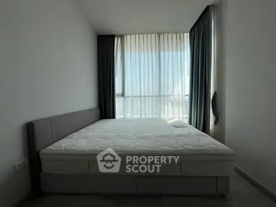 Modern minimalist bedroom with large window and stylish curtains