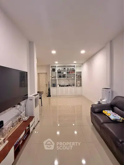 Spacious living room with modern decor and built-in shelving