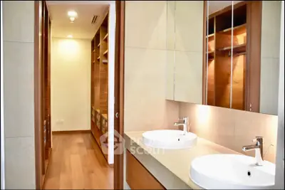 Luxurious bathroom with dual sinks and walk-in closet in modern home
