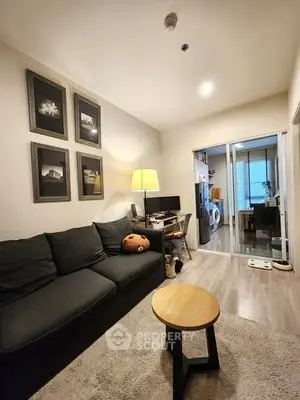 Cozy living room with modern decor and adjacent laundry area