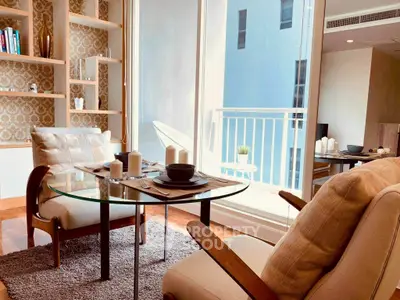 Chic living room with elegant decor and balcony access in modern apartment.