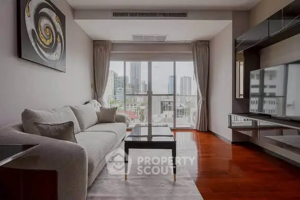 Modern living room with city view, featuring elegant decor and large windows for natural light.