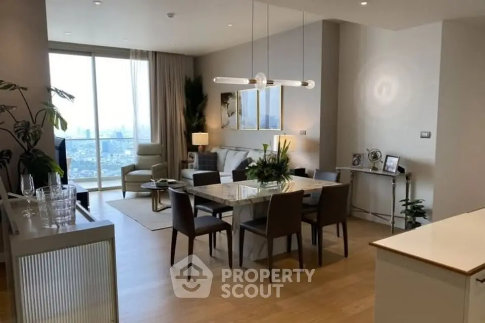 Modern open-plan living and dining area with city view, elegant furniture, and natural light.