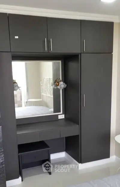 Modern bedroom with sleek built-in wardrobe and elegant mirror design
