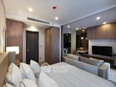 Modern studio apartment with open layout, featuring cozy living area and stylish bedroom.