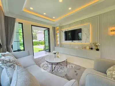 Luxurious living room with elegant decor and garden view, featuring modern furniture and ambient lighting.