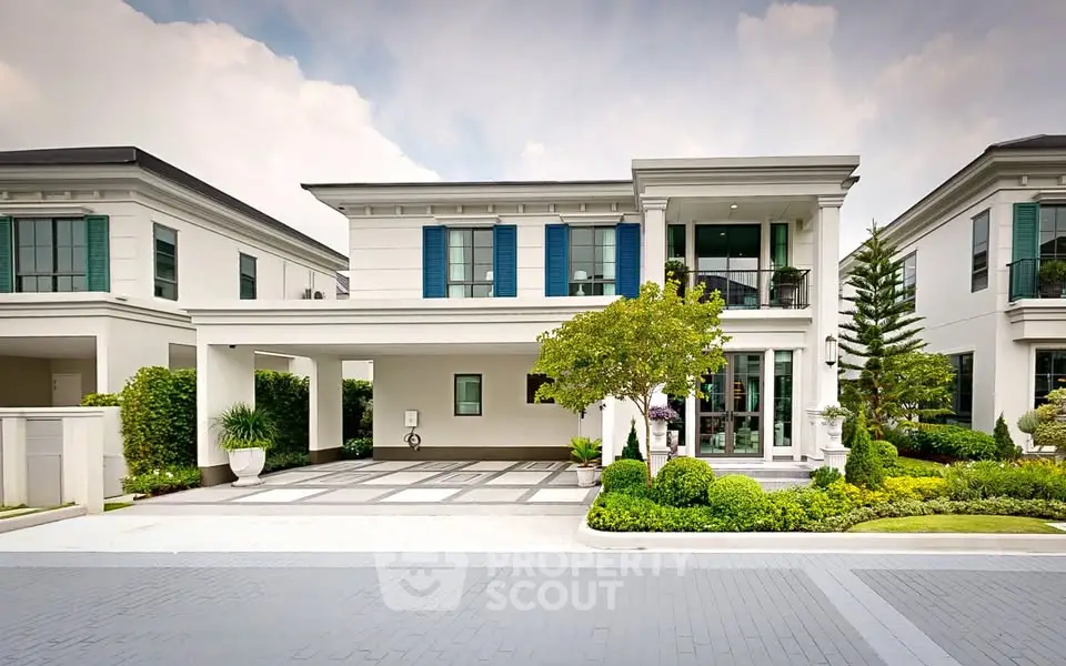 Luxurious modern villa with elegant facade and lush landscaping in upscale neighborhood.