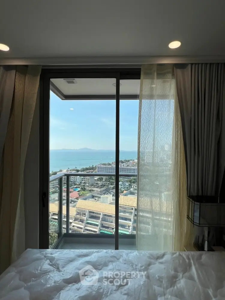 Stunning ocean view from modern bedroom with balcony access