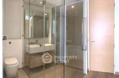 Modern bathroom with glass shower and sleek fixtures