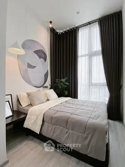 Modern bedroom with stylish decor and floor-to-ceiling windows