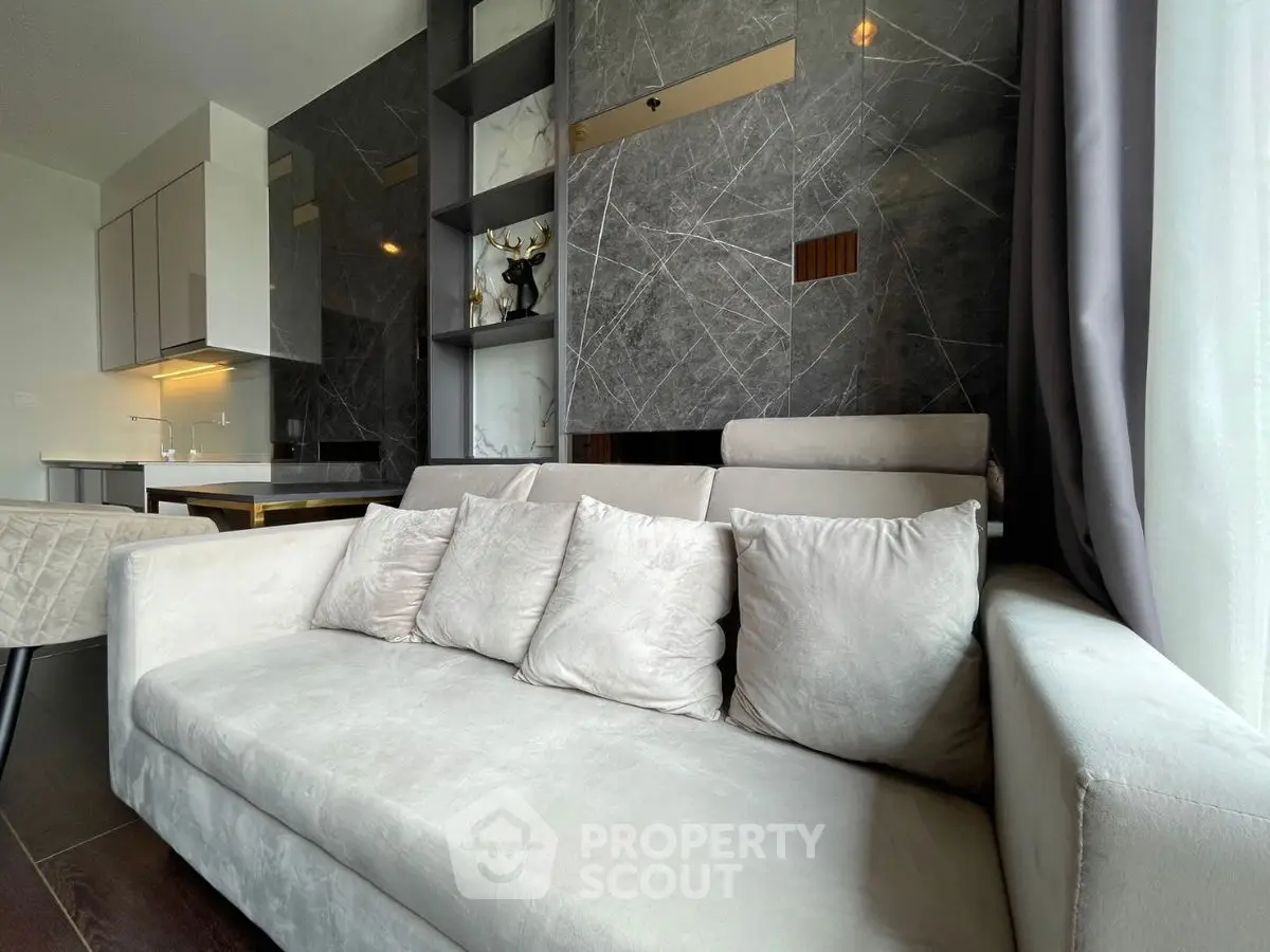 Modern living room with plush sofa and elegant marble wall accents