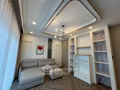 Modern living room with stylish ceiling design and cozy gray sofa