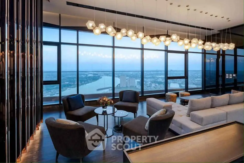 Luxurious living room with panoramic city and river views, featuring modern furniture and elegant lighting.