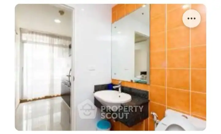 Modern bathroom with orange tiles and sleek fixtures
