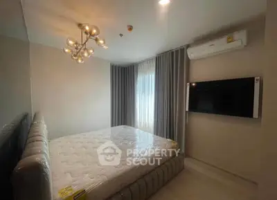 Modern bedroom with stylish lighting and wall-mounted TV in a cozy apartment.