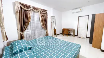 Spacious bedroom with elegant curtains and modern furnishings