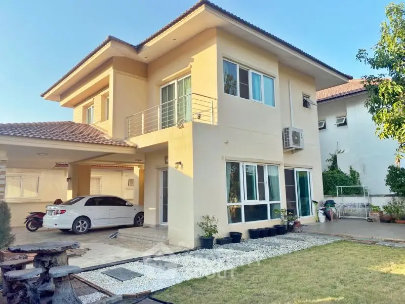 Charming two-story house with spacious garden and carport in serene neighborhood.