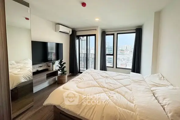 Modern bedroom with large windows and city view, featuring a cozy bed and sleek decor.