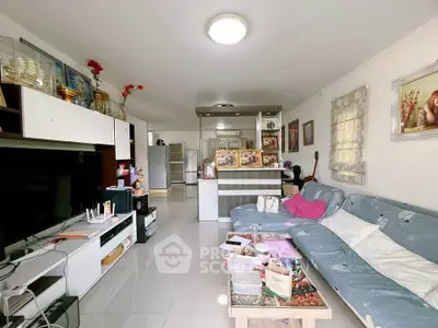 Spacious living room with modern decor and open kitchen layout