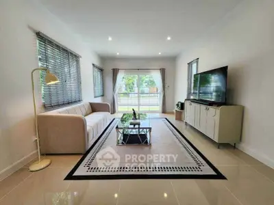 Spacious modern living room with large windows and elegant decor