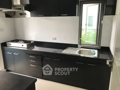 Modern kitchen with sleek black cabinetry and gas stove